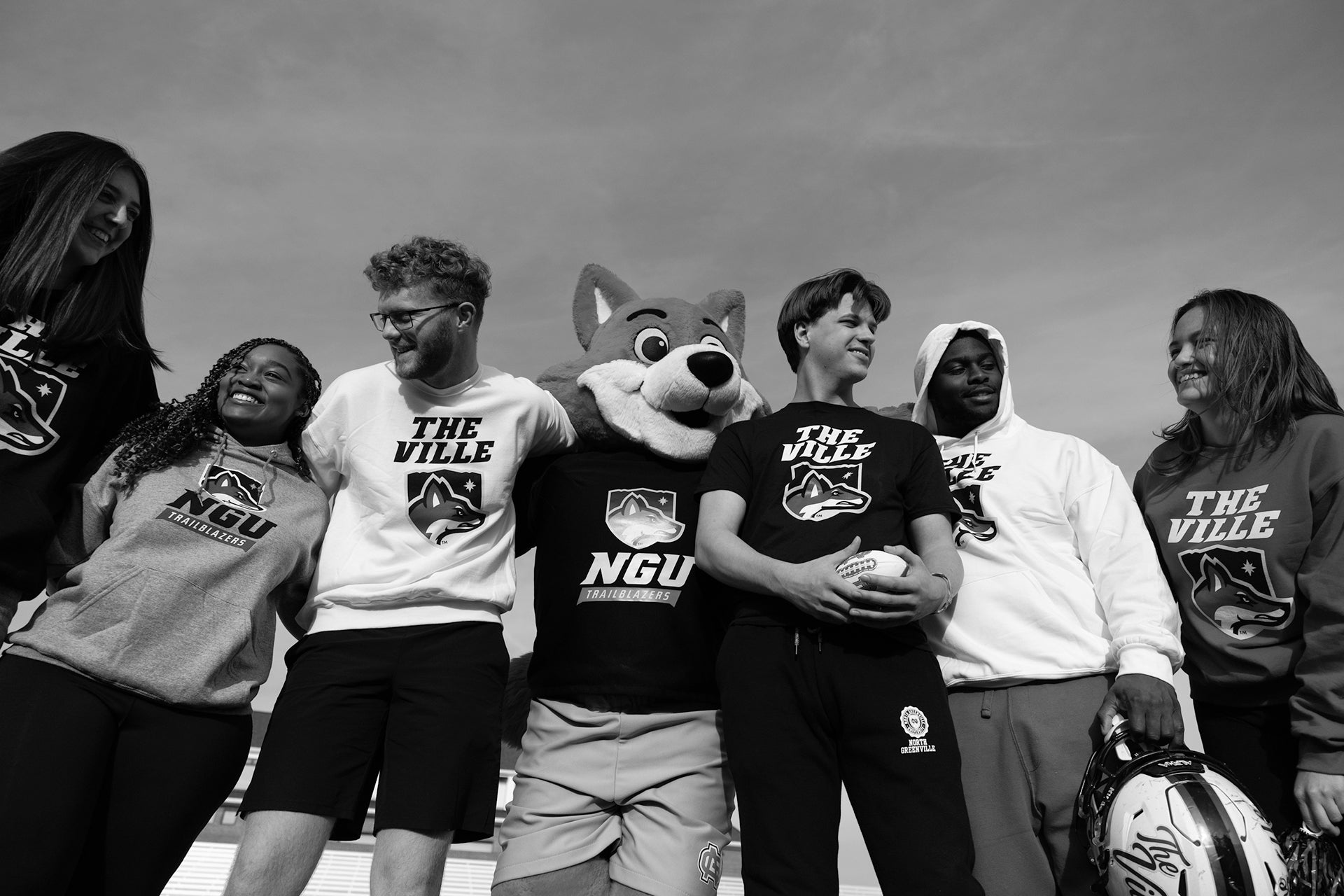 Group of people wearing NGU sweatshirts and a mascot in the center.